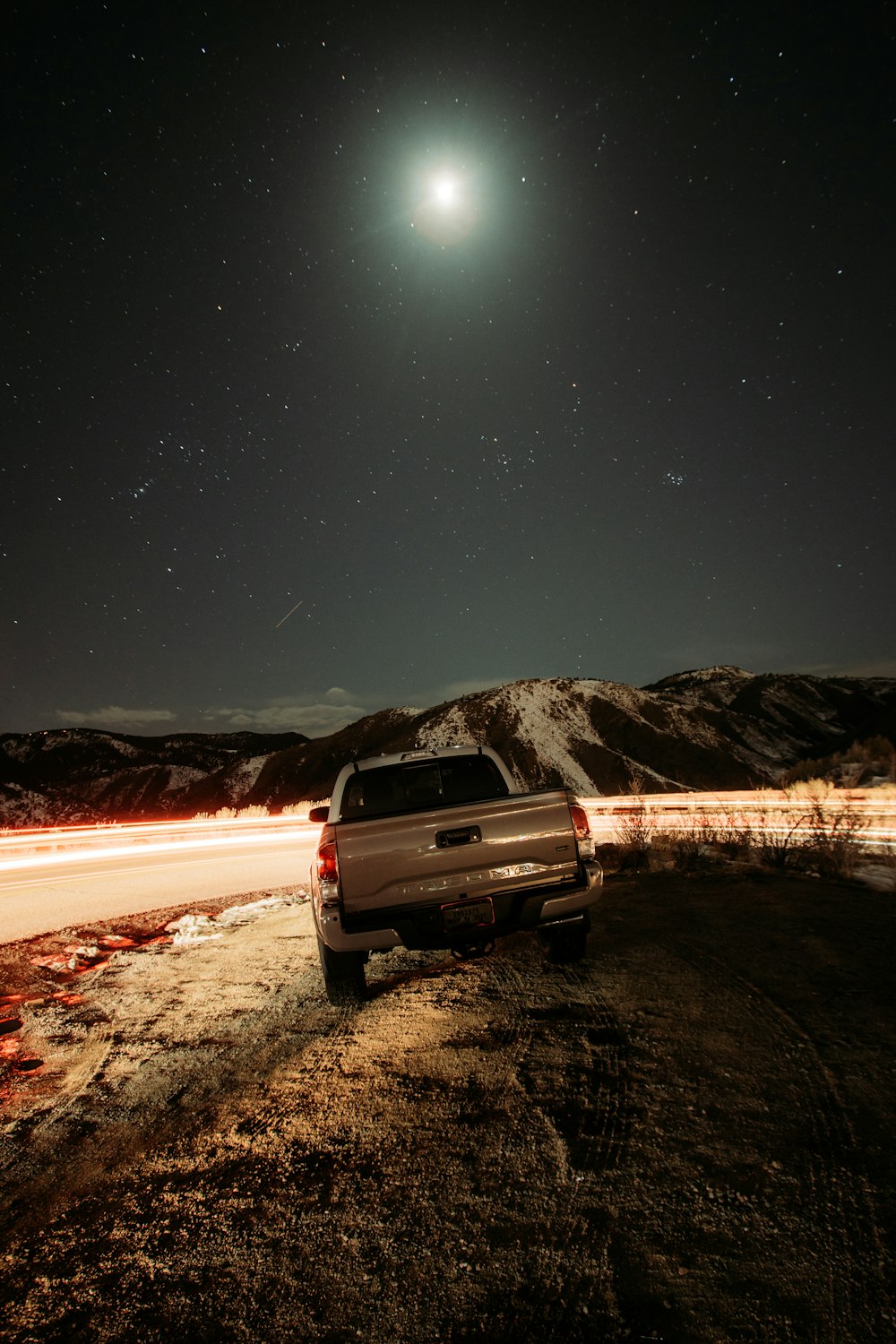 white suv on road during night time