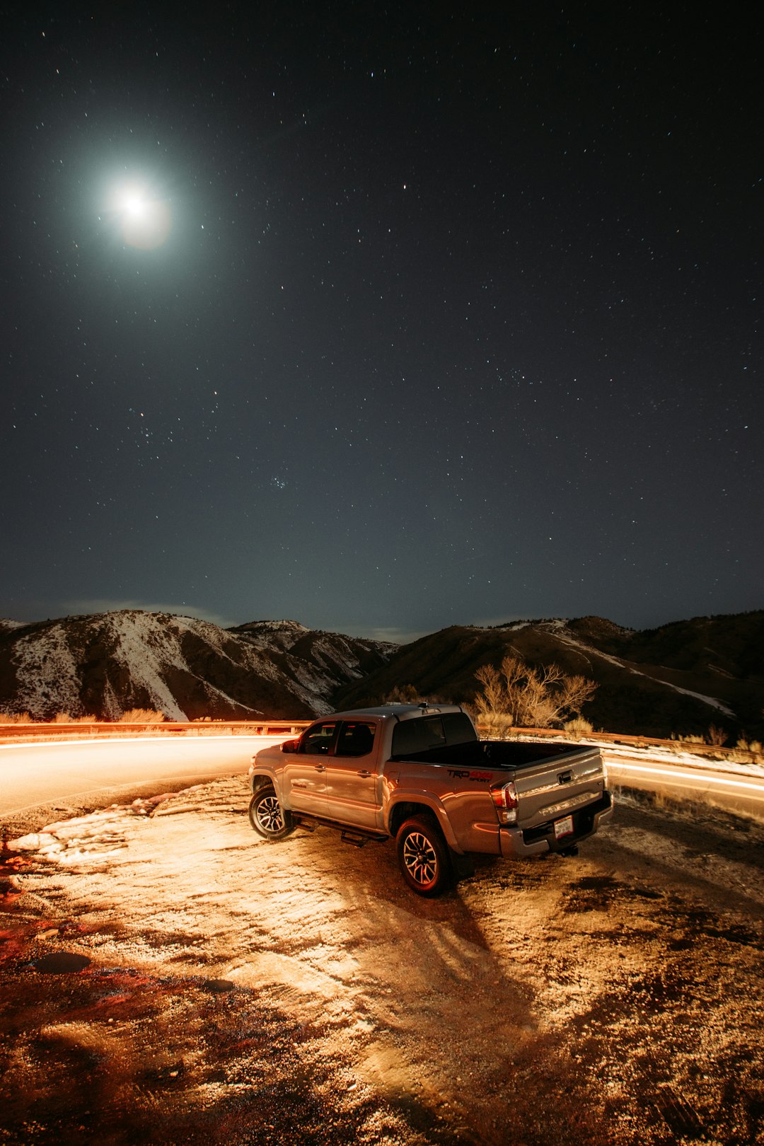 black suv on brown sand during night time