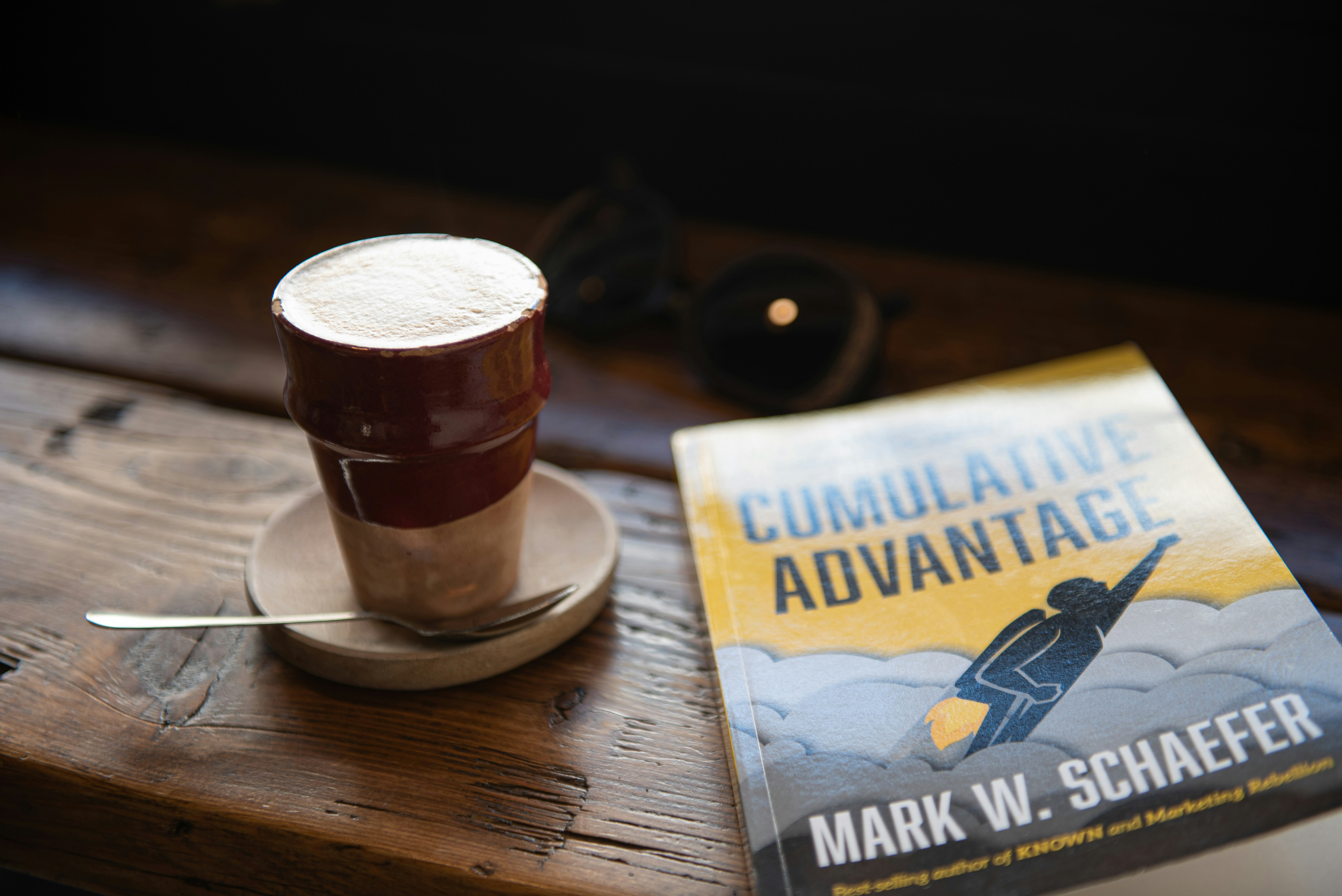 brown and white ceramic mug on brown wooden table