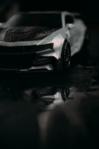 Sunlit car entrance with sparkling wet paint reflecting a fresh wash