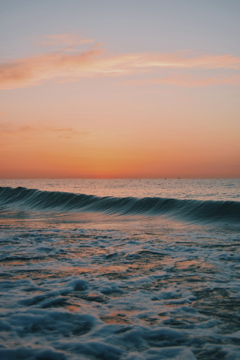 ocean waves under blue sky during daytime