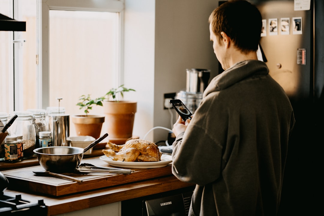 man in gray coat standing in front of table with food