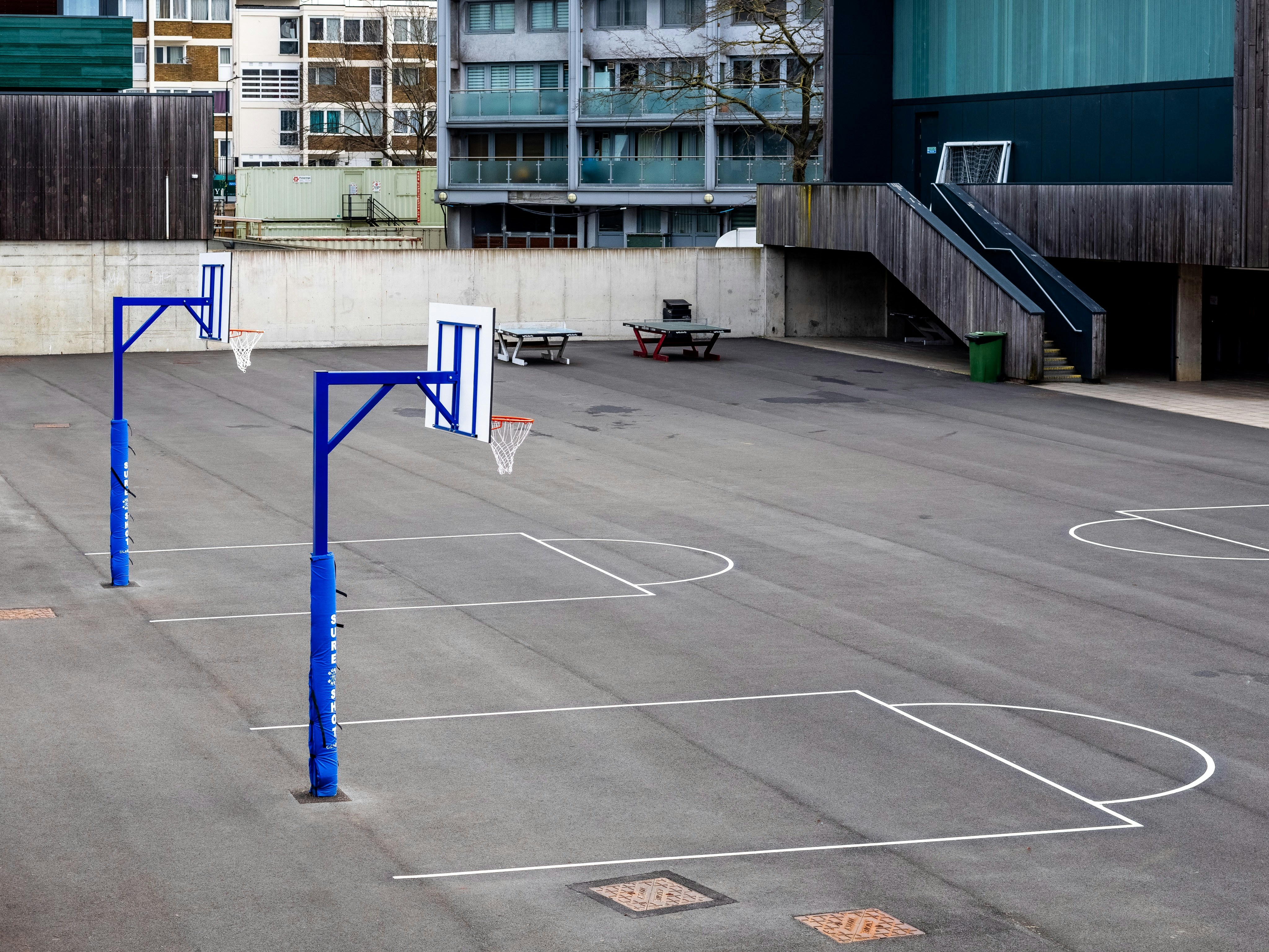 blue and white metal post on basketball court