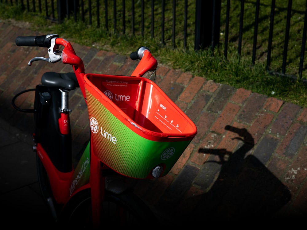 red and black bicycle with training wheels