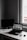 Modern minimalist workspace with a laptop displaying an online shopping website.