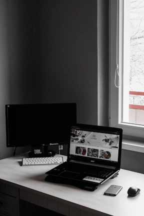Minimalist workspace with a laptop displaying discount website