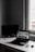 Modern minimalist workspace with a laptop displaying an online shopping website.