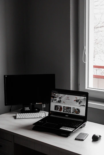 A minimalist workspace with a laptop open to a spreadsheet, bathed in natural light and calm colors.