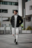 Model wearing a minimalist black vergesti jacket walking on an urban street