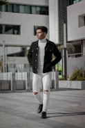 Model wearing a sleek, minimalist jacket walking through a busy city street.