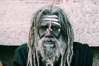 man in black shirt with black and white face paint