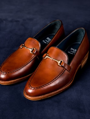 brown leather loafers on blue textile