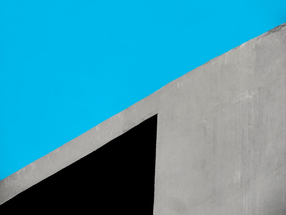 gray concrete wall under blue sky during daytime