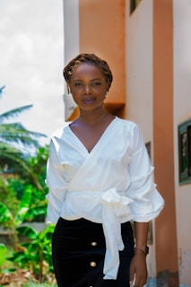 woman in white dress shirt and black skirt