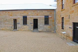 A calm prison yard where inmates reflect quietly