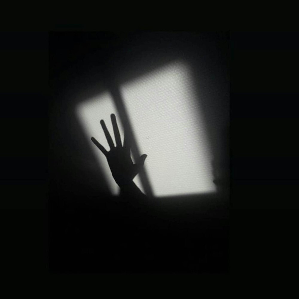 silhouette of a person raising his hand