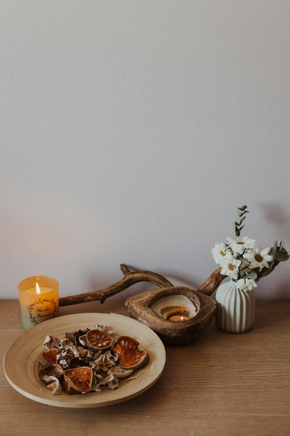 brown wooden spoon beside white flower on brown wooden table