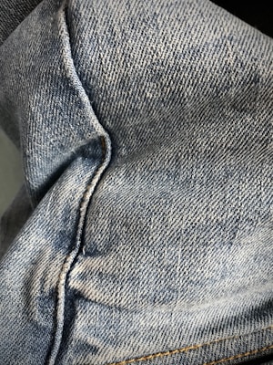 Close-up of eco-friendly denim jeans with visible stitching and natural dye textures.