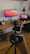 A vibrant workspace with creative designs and photography equipment displayed on a desk.