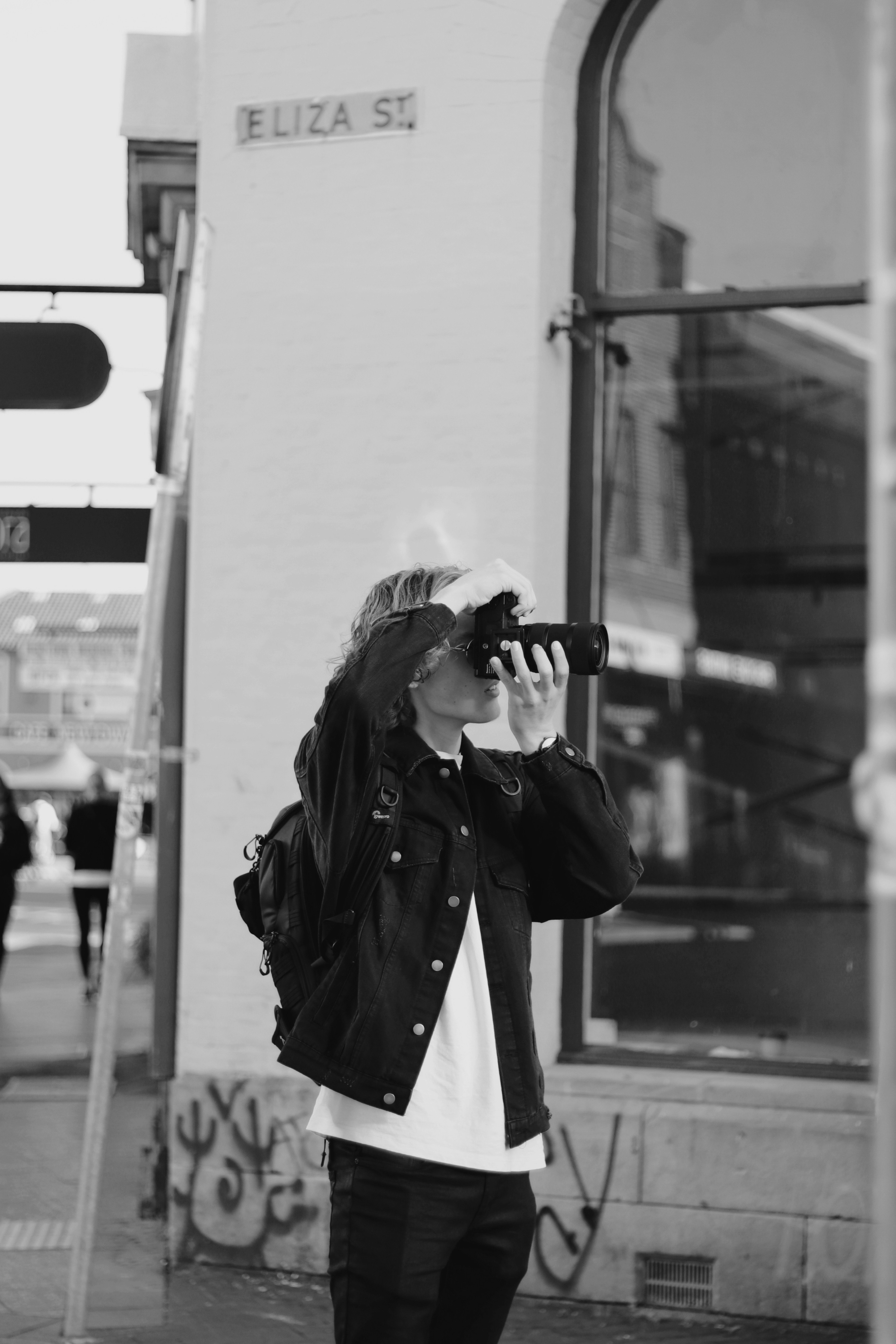 woman in black coat wearing black sunglasses