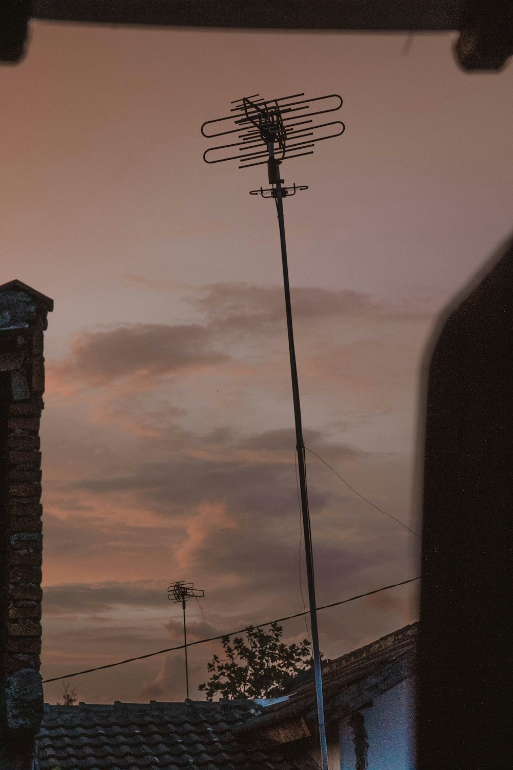 black electric post under cloudy sky during daytime