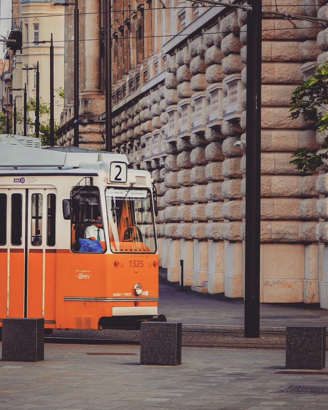 orange and white tram on road during daytime