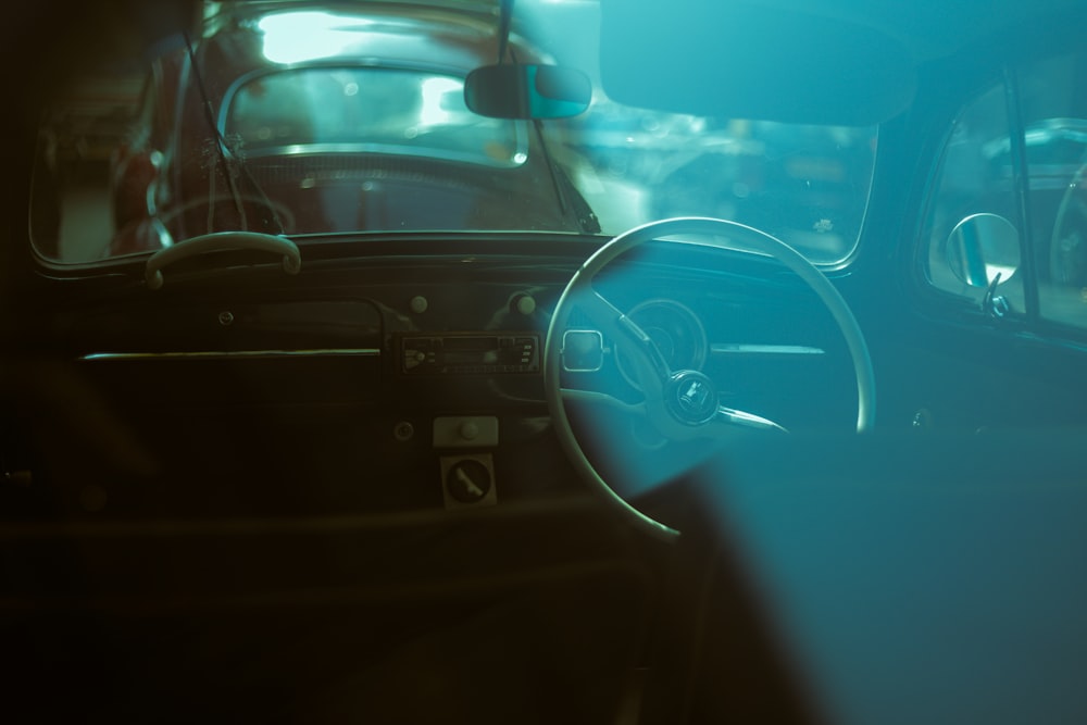 black car steering wheel during daytime