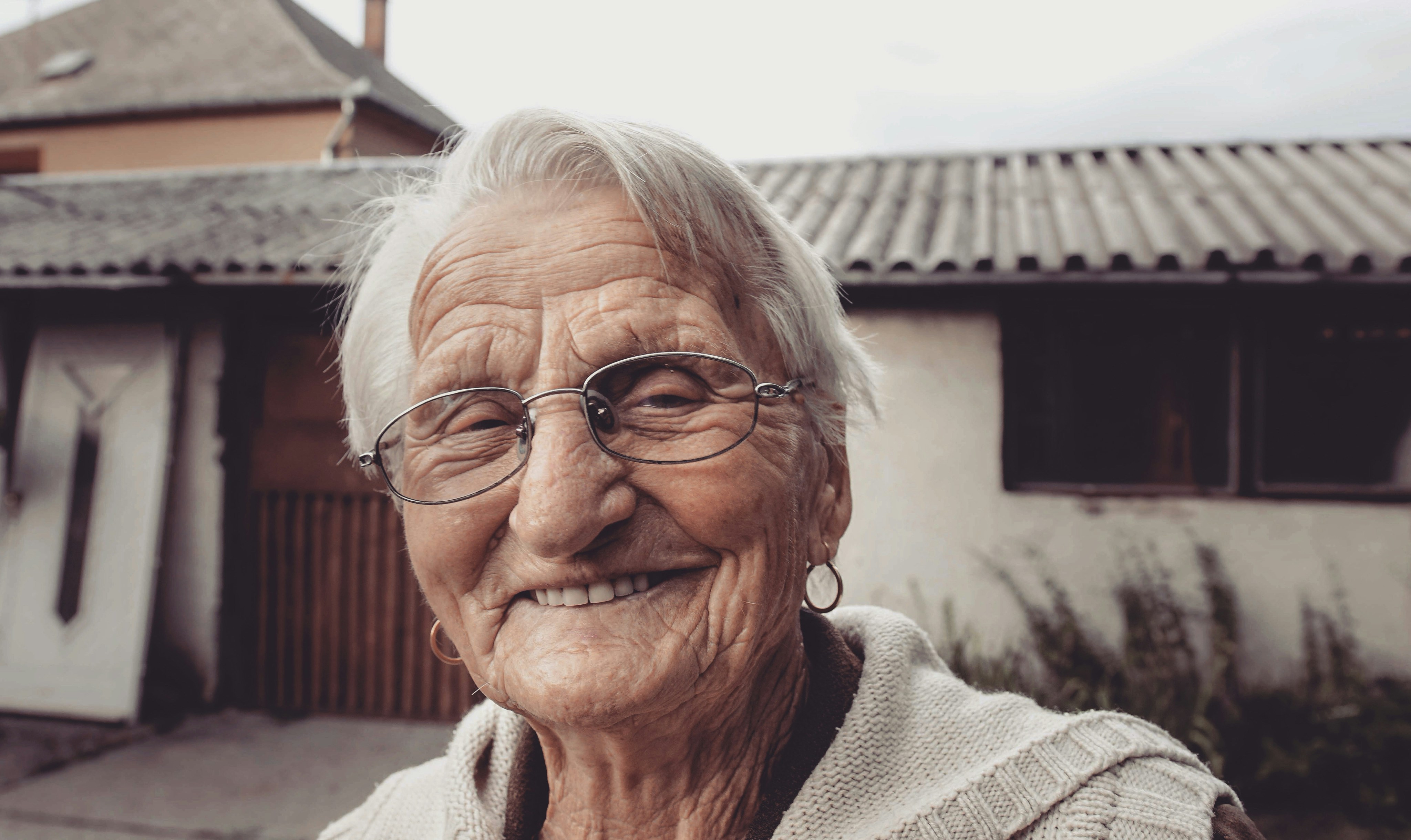woman in gray sweater wearing black framed eyeglasses
