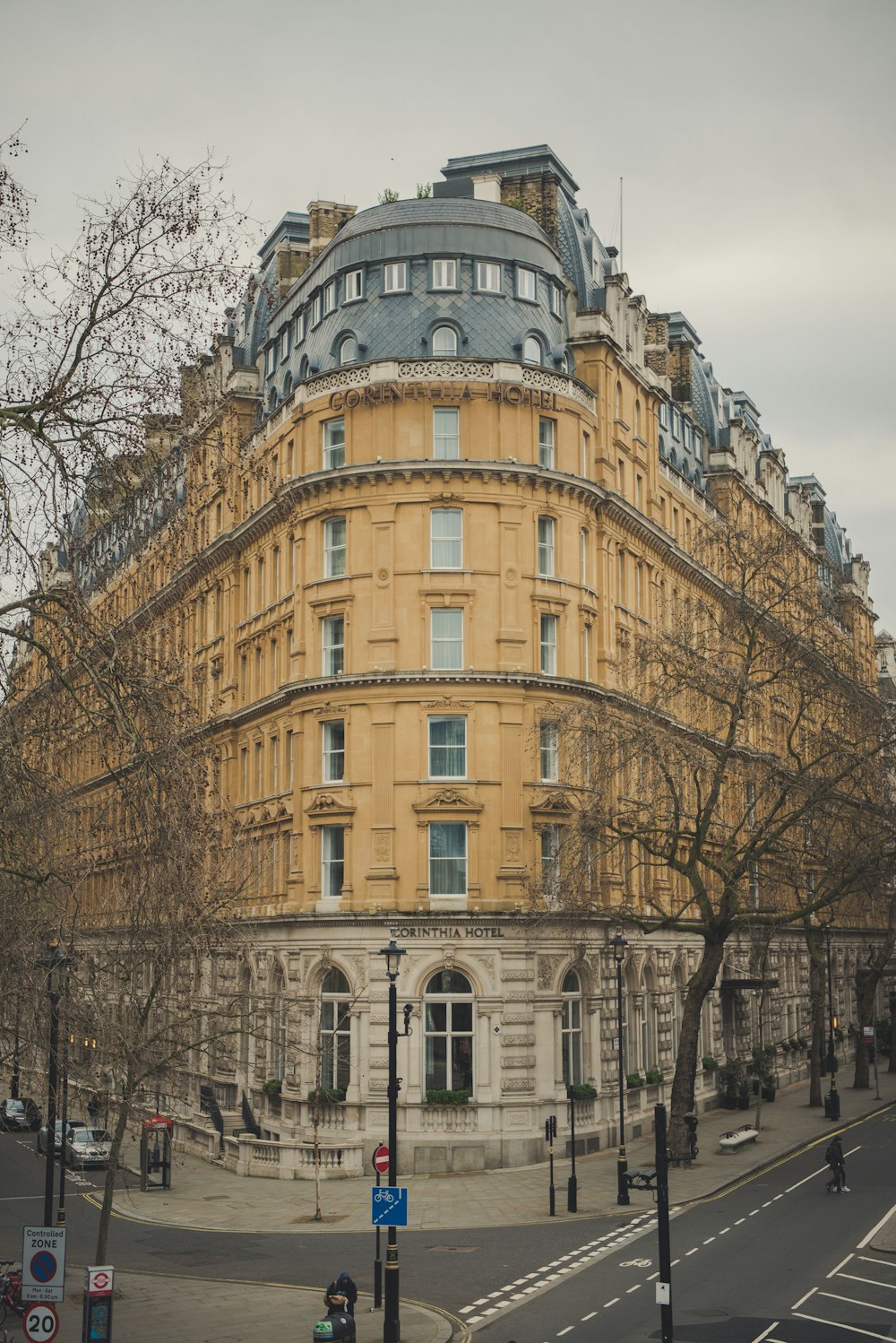 brown concrete building near bare trees during daytime