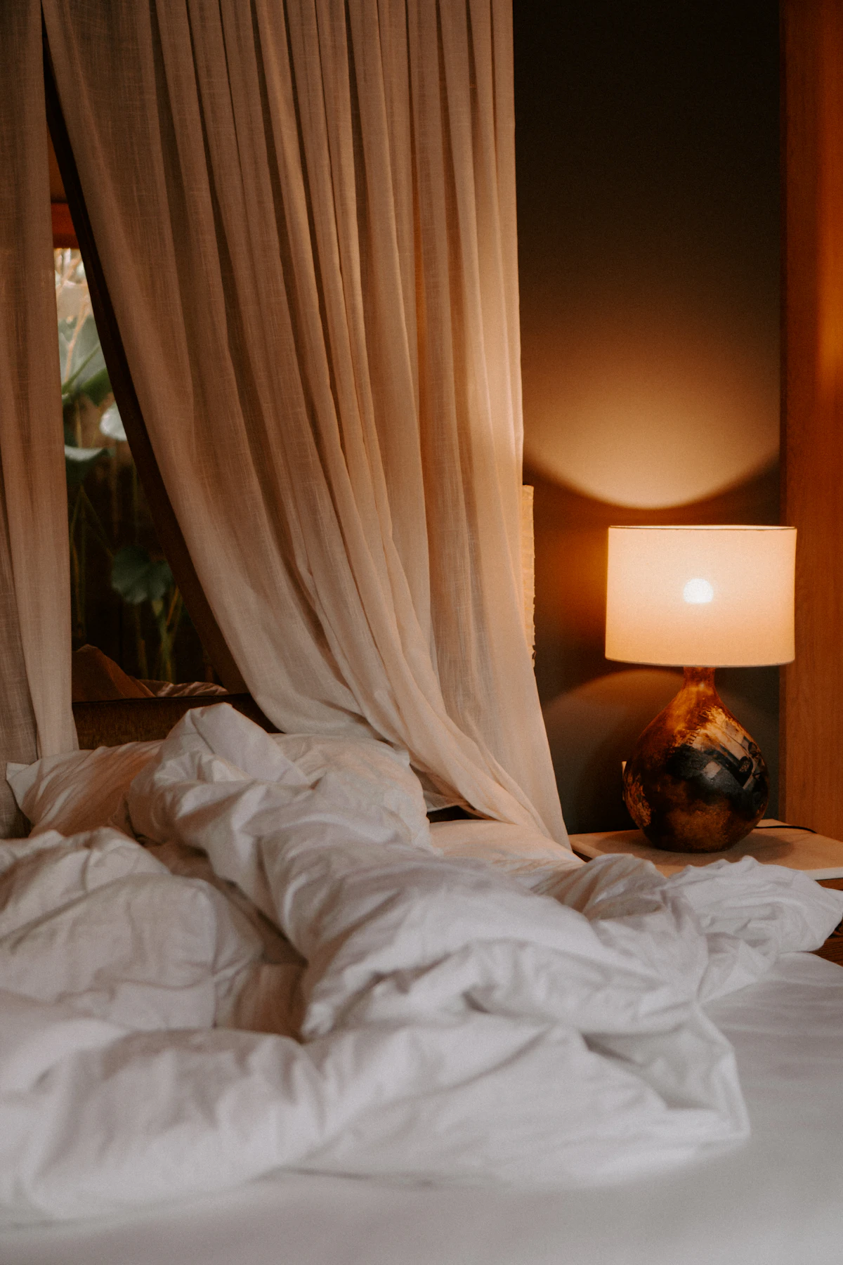 Bedside lamps providing warm, focused reading light either side of a bed