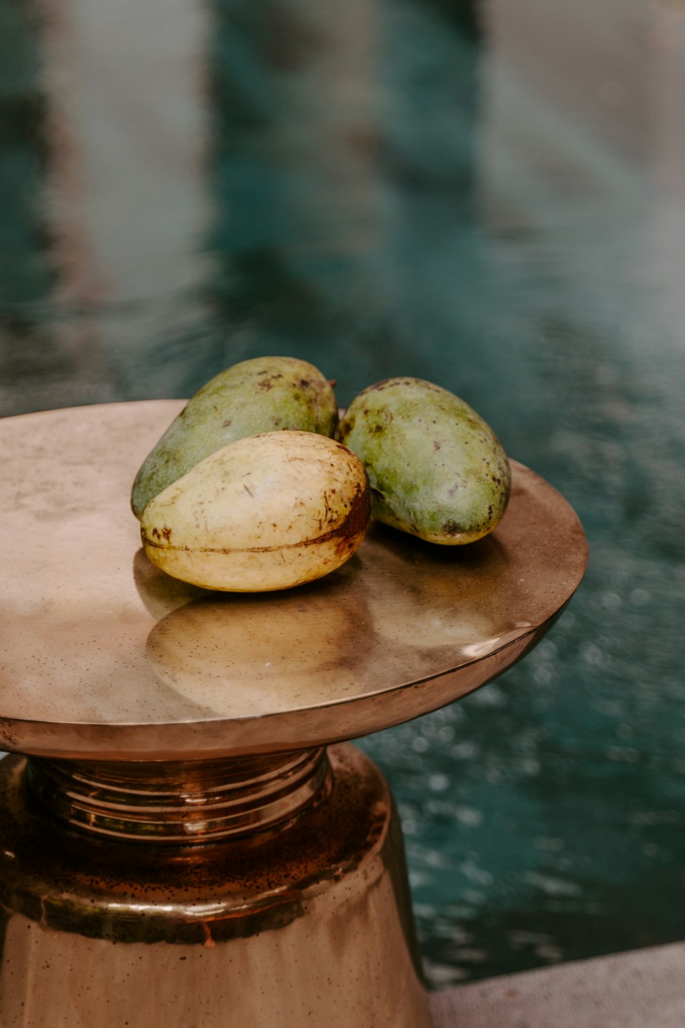 frutta rotonda verde e marrone su tavolo rotondo in legno marrone