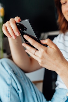 a close up of a person holding a cell phone