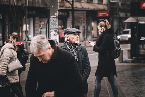 A group of friends walking together while using their phones.