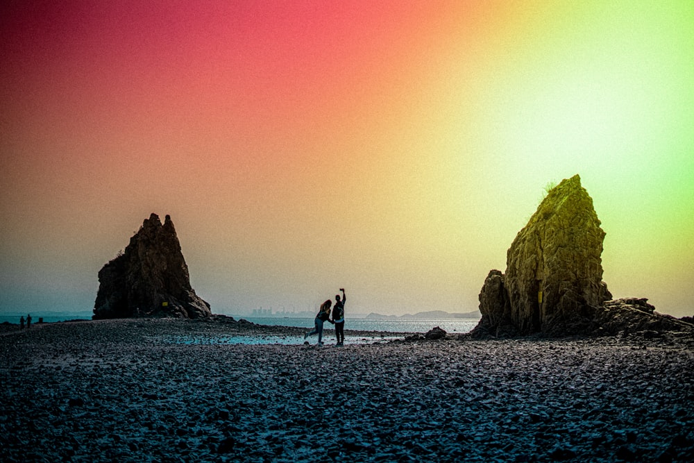 man and woman walking on beach during sunset