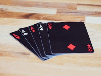black and white playing cards on brown wooden table