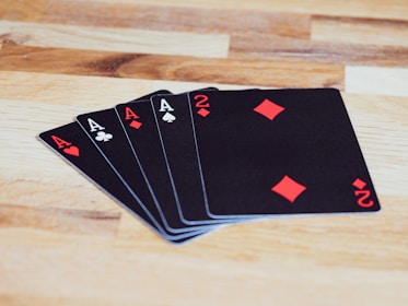 black and white playing cards on brown wooden table