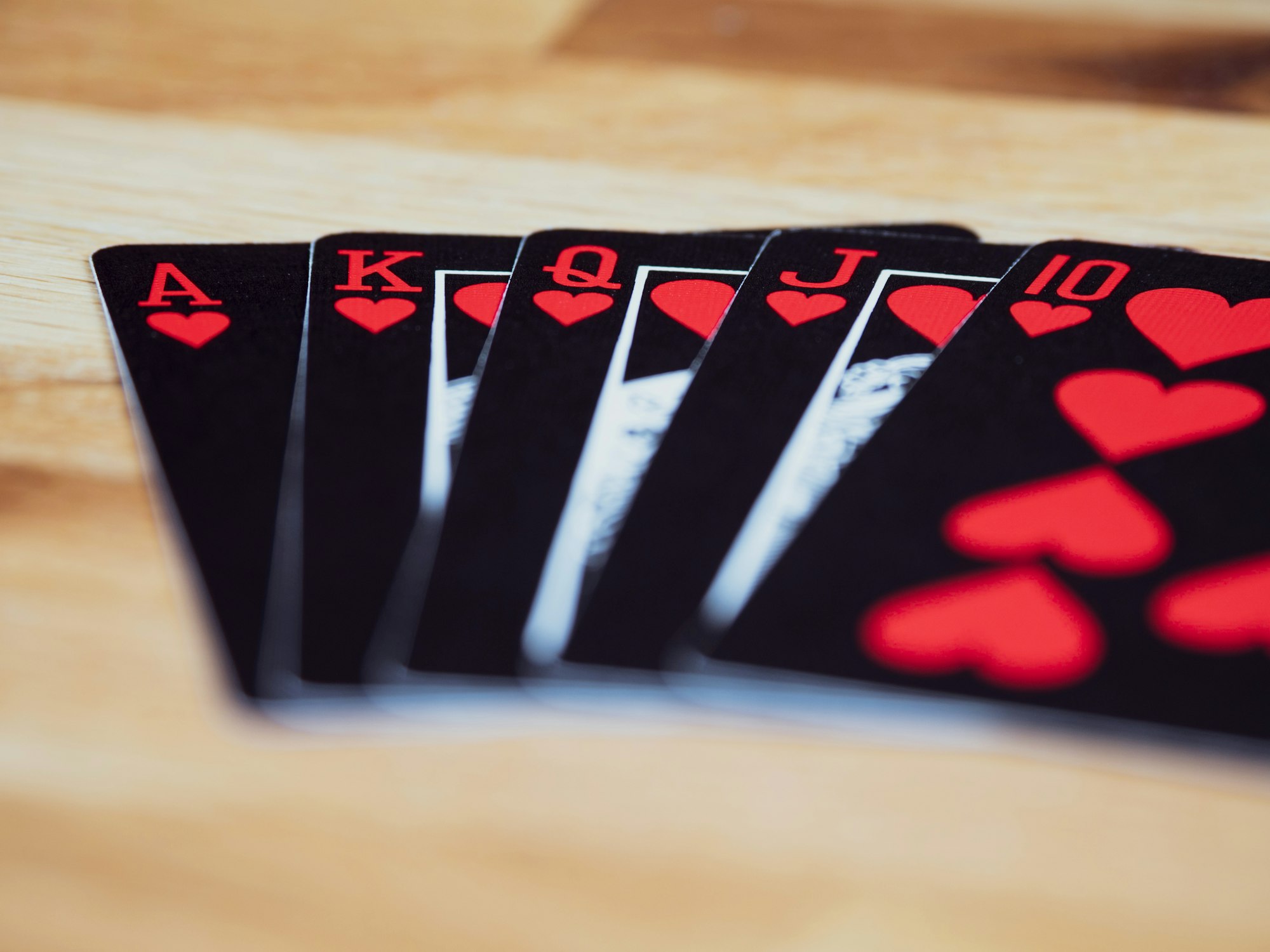cards, playing cards, gambling, close up, bokeh, wood background, product shot, focus, deal, 
