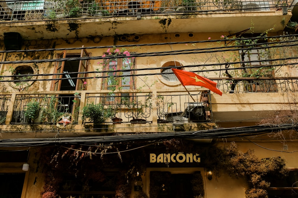 red flags on brown concrete building during daytime