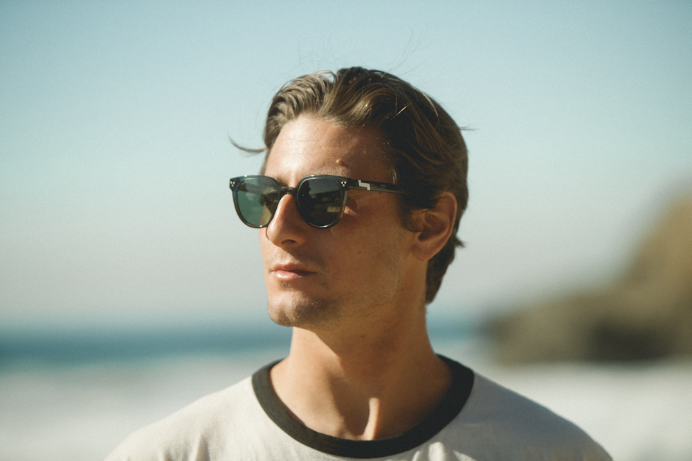 man in white crew neck shirt wearing black sunglasses