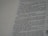 A close-up view of a page from a book, featuring text in a serif font. The text appears to be a narrative or dialogue, with numbered lines and a clear structure. The background is a pale color, likely the paper of the book.