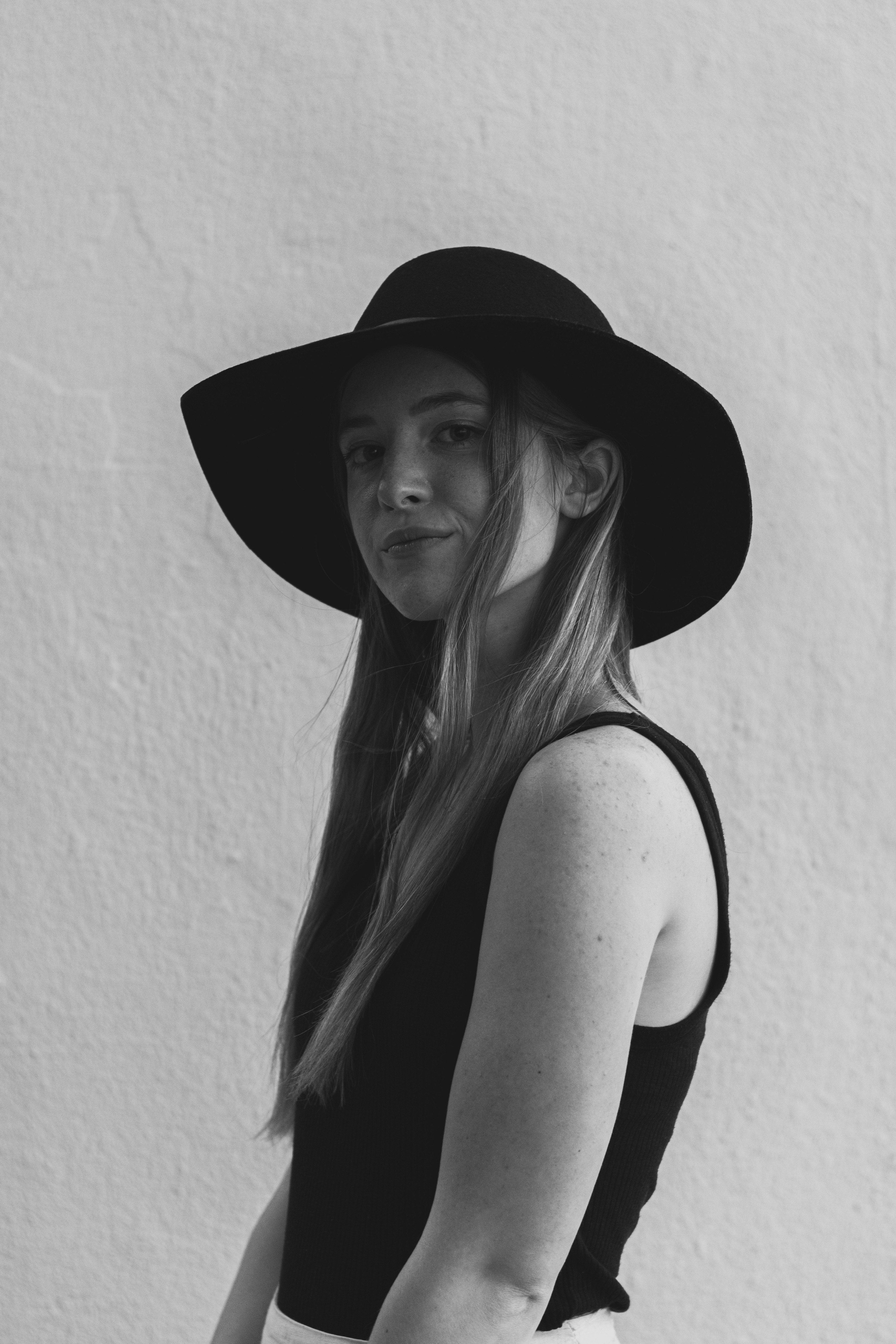 woman in black hat and tank top