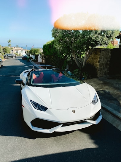 white lamborghini aventador parked on parking lot during daytime