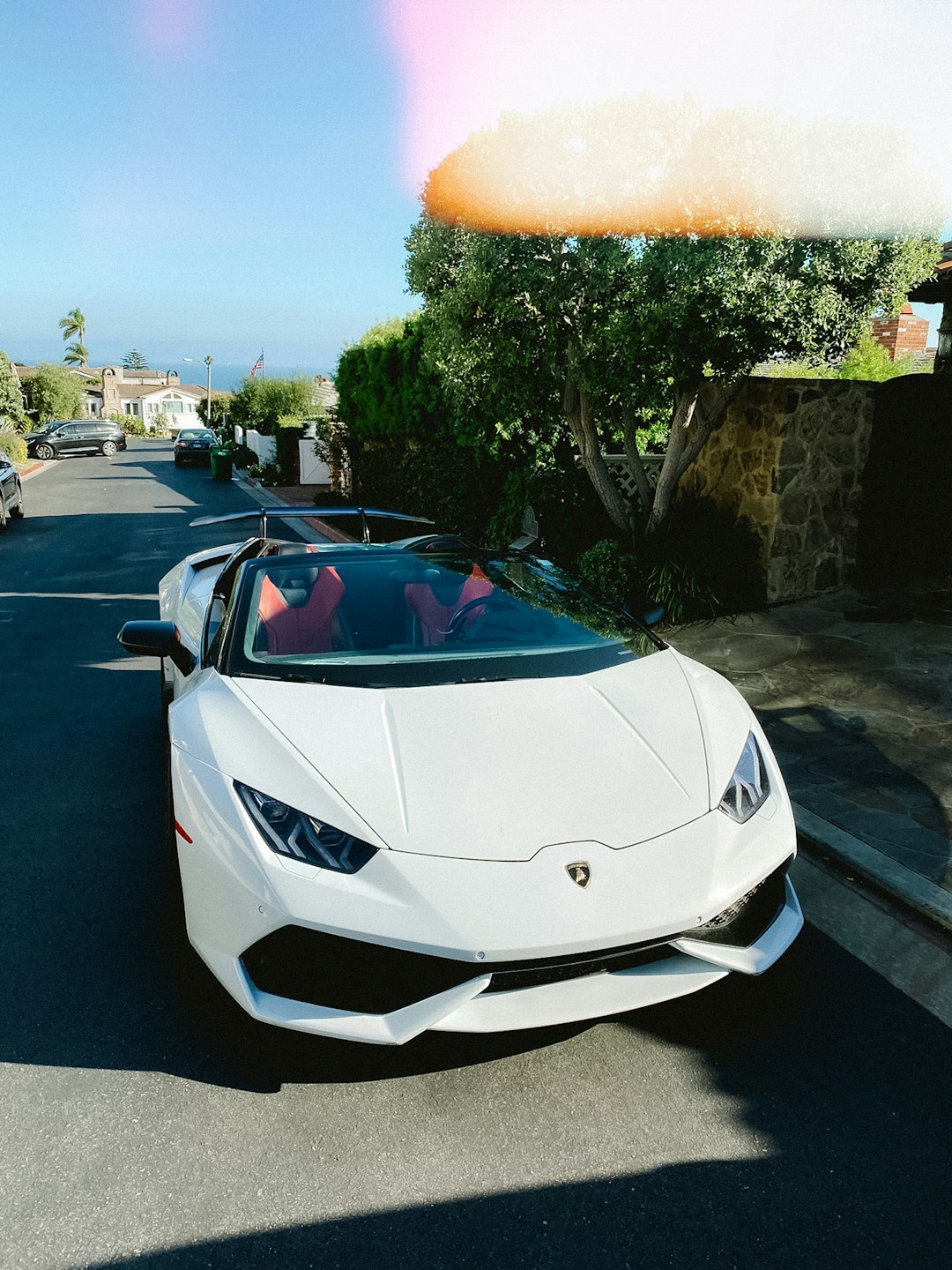 white lamborghini aventador parked on parking lot during daytime