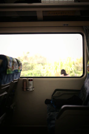 Steam rising gently from a freshly brewed coffee cup inside a first-class train cabin, capturing a moment of calm.