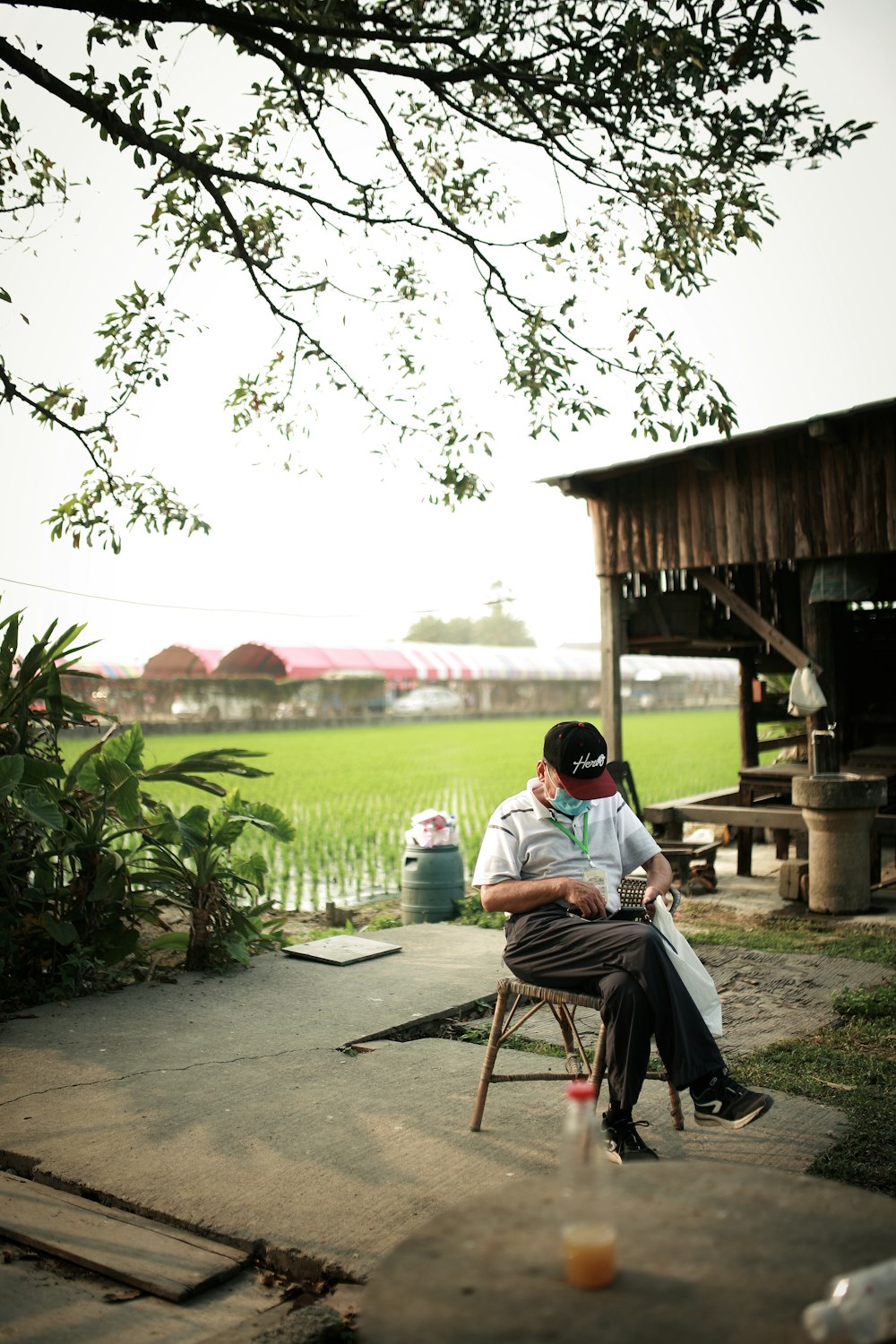 man in white shirt sitting on brown wooden chair