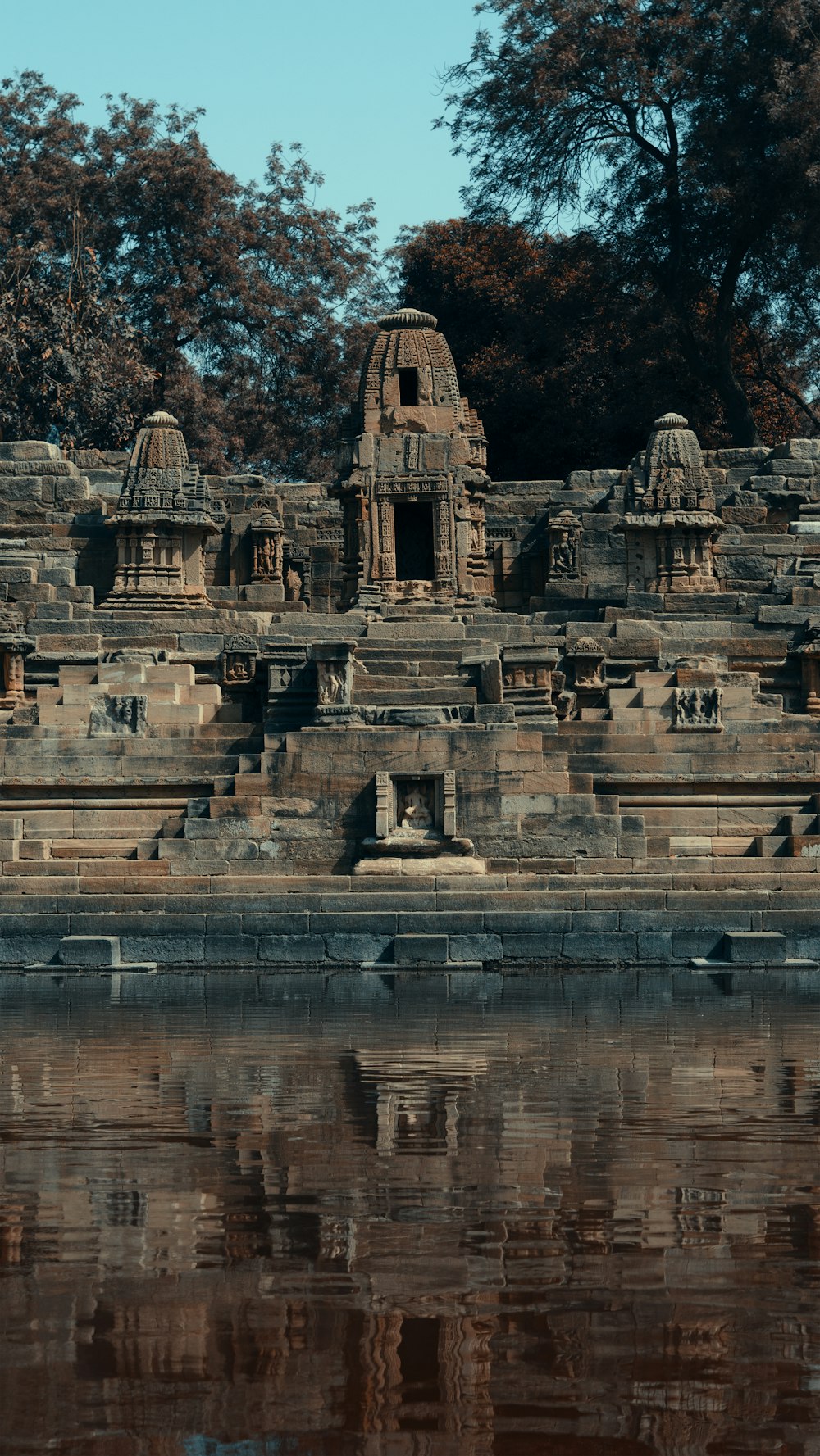 gray concrete building near body of water during daytime