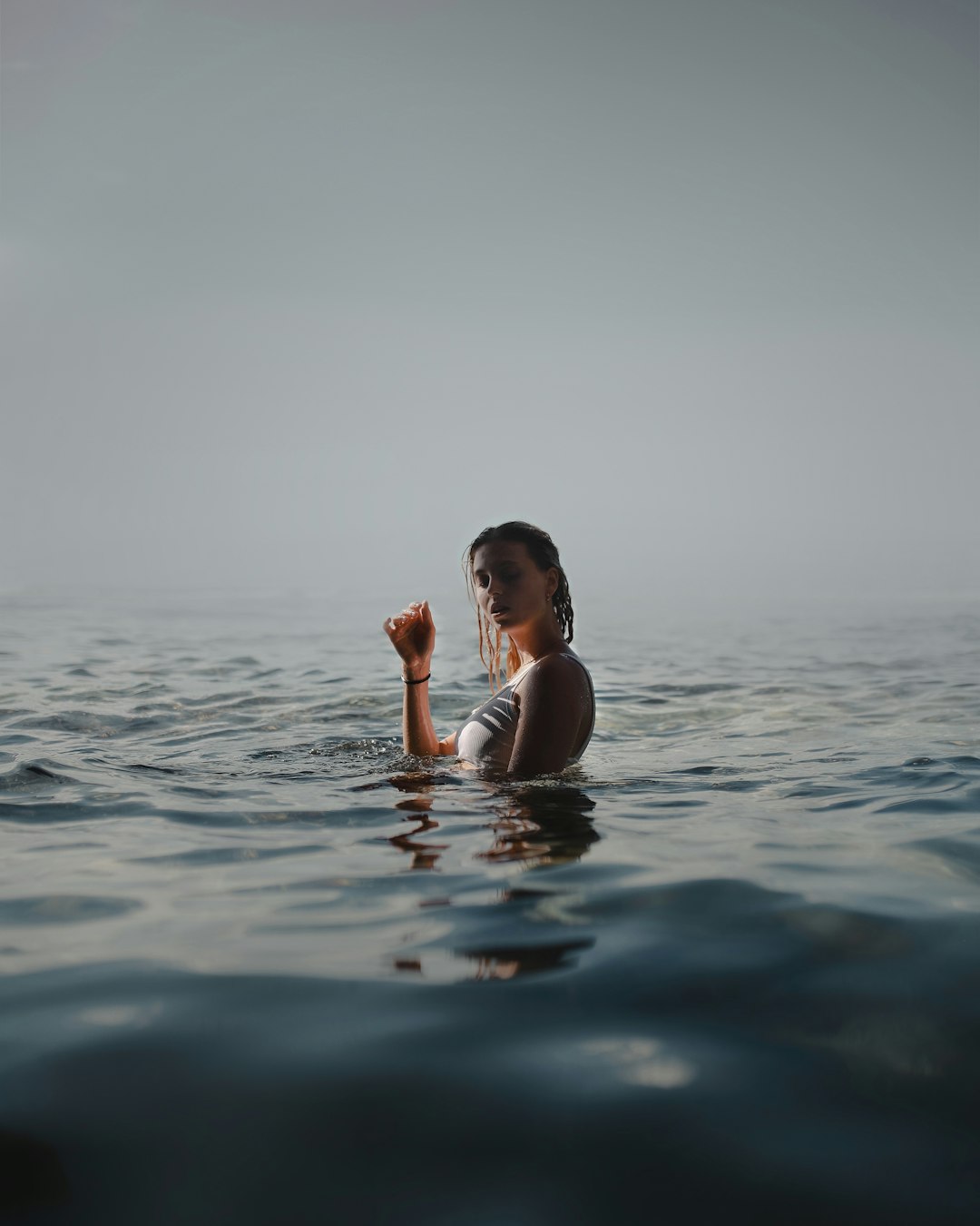 woman in black bikini top on water