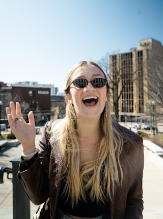 woman in brown sunglasses and brown shirt