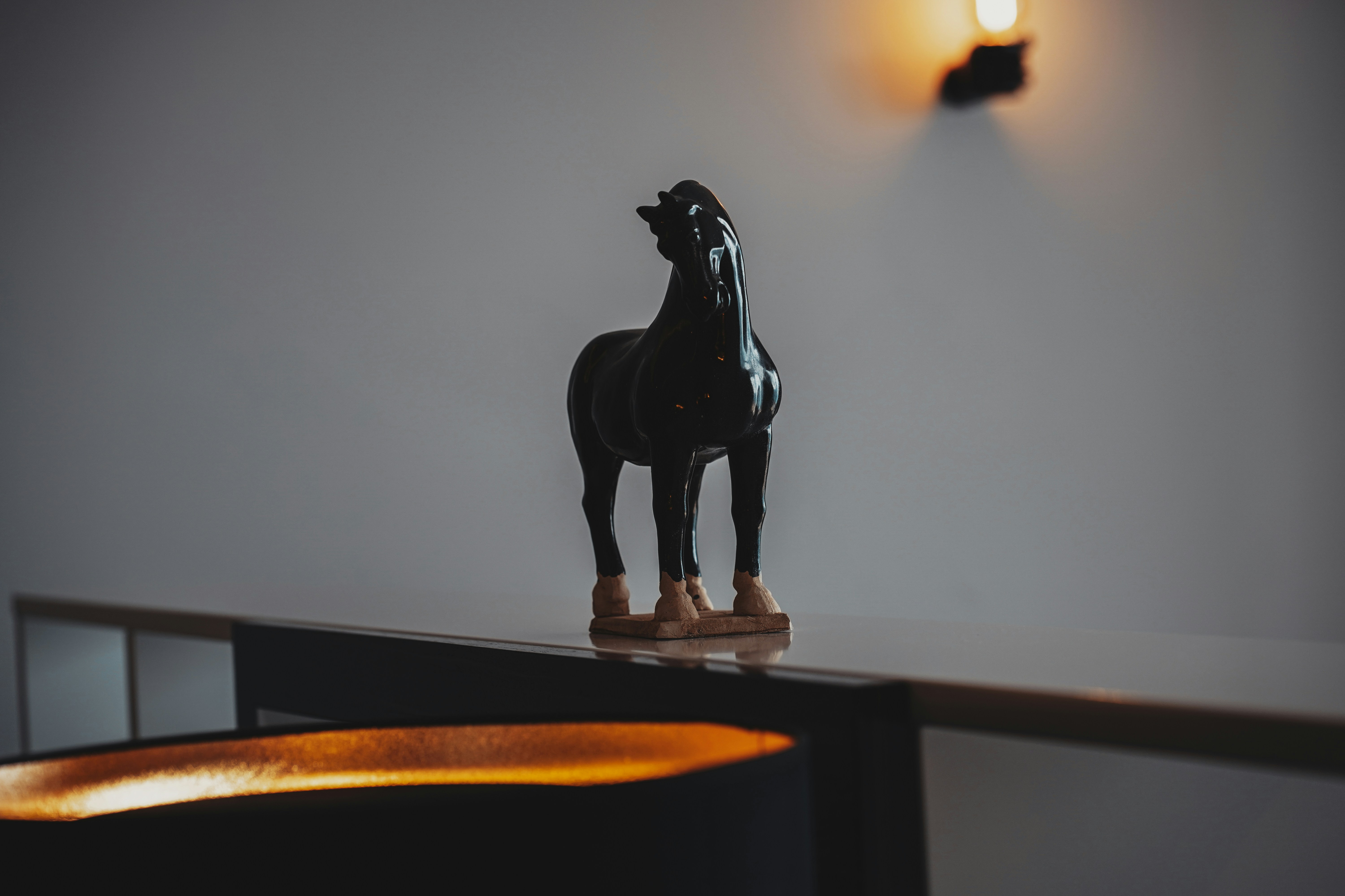 black horse figurine on brown wooden table