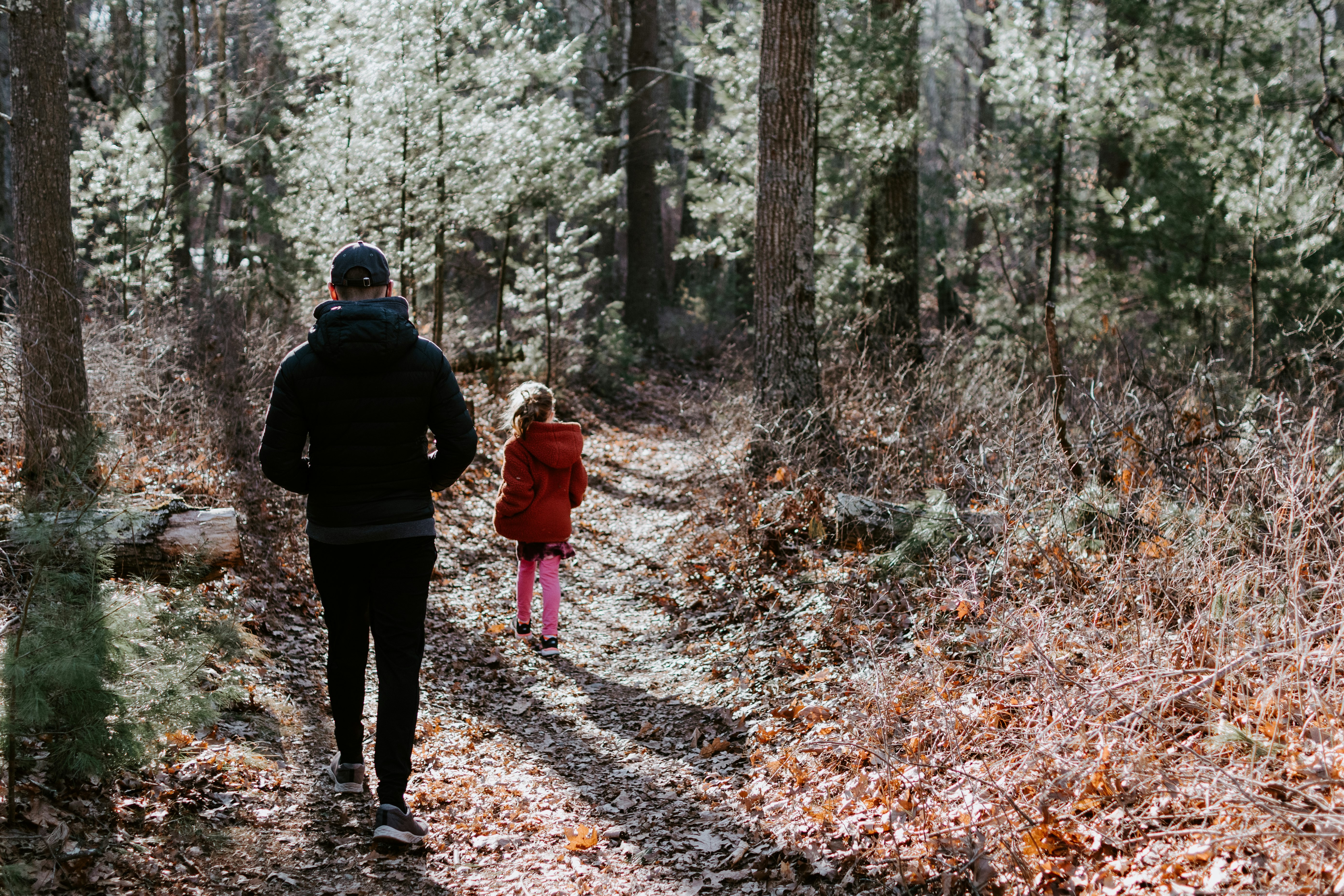 Father and daughter walking a trail together